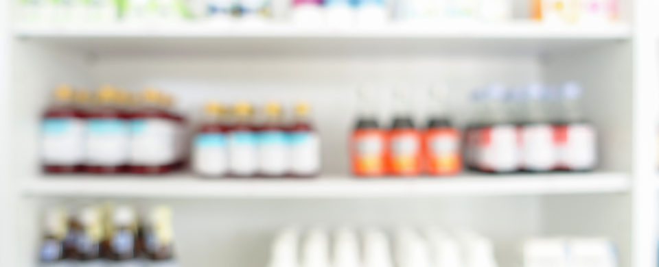 Blurry photo of non-descript medications on shelves